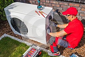 Technician Repairing Heat Pump Unit