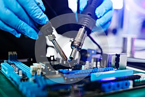The technician repairing the motherboard in the lab with copy space. the concept of computer hardware, mobile phone, electronic,