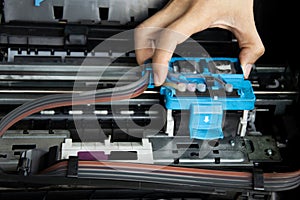 Technician repairing printer, fixing printer head