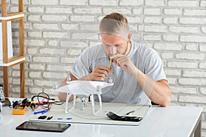 Technician Repairing Quadrocopter Drone