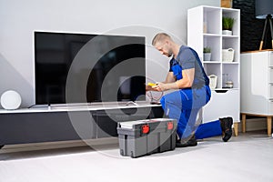 Technician Repairing Television