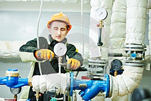 Technician or repairman installing manometer in boiler room