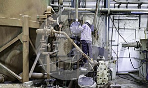 Technician are reparing breakdown machine in factory