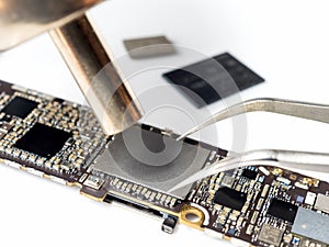 Technician replacing flash storage of smartphone motherboard