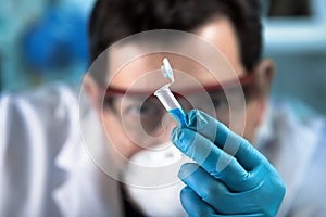 Technician researcher holding pcr tube for analytical in the clinical laboratory