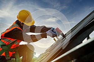 Technician Roofer worker in protective uniform wear and gloves, Construction worker install new roof,Roofing tools,Electric drill