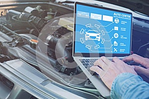 Technician`s hand using computer analyze the data of the car To check engine operation, technology for vehicle maintenance concep