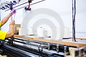 The technician`s hand working with textile factory in spinning production line and a rotating machinery and equipment production