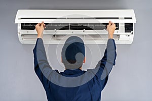 Technician service checking and repairing air conditioner