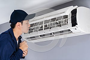 Technician service checking and repairing air conditioner