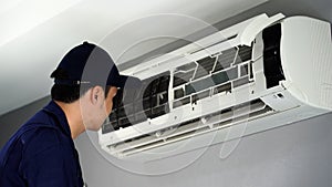 Technician service removing air filter of air conditioner for cleaning