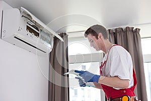 technician service removing air filter of the air conditioner for cleaning.