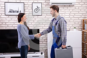 Technician Shaking Hands With Woman