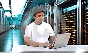 Technician Sitting next to the server in the data storage room