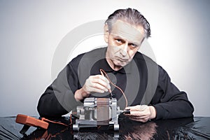 Technician in studio checking washing machine engine