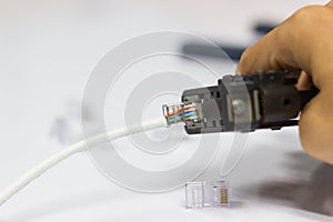 Technician to install an RJ45 connector on a CAT5