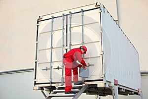 technician with tool case opening movable workshop in container photo