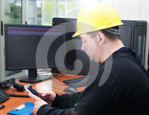 Technician typing the message in the power plant control center