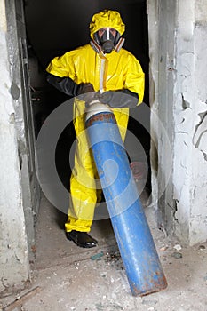 Technician in uniform with steel cylinder