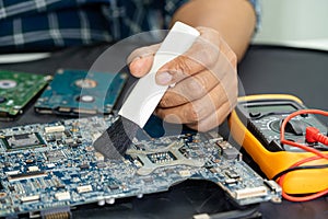 Technician use brush and air blower ball to clean dust in circuit board computer. Repair upgrade and maintenance technology