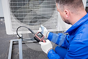 the technician uses a digital camera to check the clogging of the heat exchanger