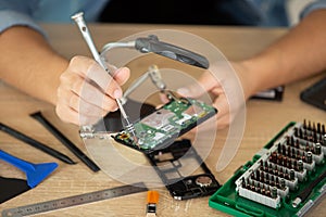 Technician uses precision tool for computer repair