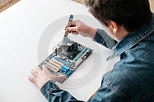 Technician using  brush for computer cleaning