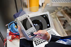 Technician using digital cable analyzer