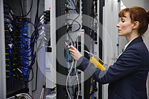 Technician using digital cable analyzer on server