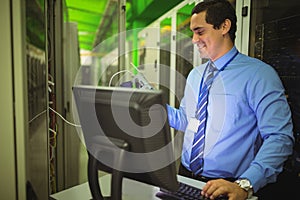 Technician using digital cable analyzer while working on personal computer