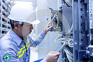 Technician using digital tablet in server room, repair card mainboard checking network link status