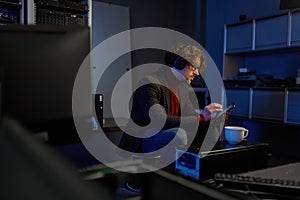 IT technician using digital tablet while working in data center