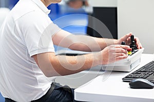 Technician is using joystick to operate electronic device