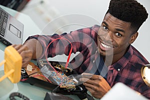 technician using voltage meter in computer