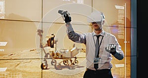 Technician using VR headset and exoskeleton gloves