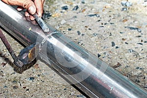 Technician is welding aluminium pipe by using soldering copper.