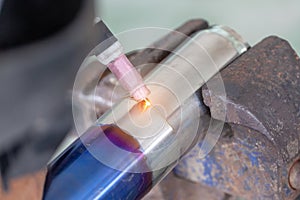 Technician is welding aluminium pipe by using soldering copper