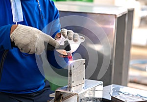 Technician welding stainless steel base with mig-mag method