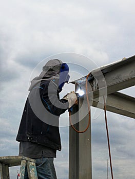 Technician welding steel structure