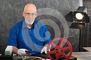 Technician with white gloves digitizing mini-DV cassette