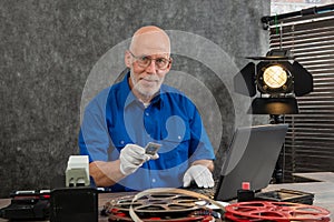 Technician with white gloves digitizing old 35mm film slide