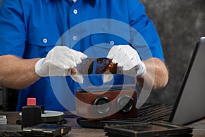 Technician with white gloves digitizing old photography on glass plate