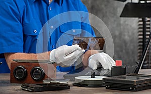 Technician with white gloves digitizing old photography on glass plate