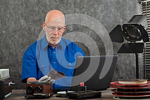 Technician with white gloves digitizing old photography on glass plate