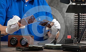 Technician with white gloves digitizing old photography on glass plate