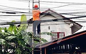Technician on wooden ladder Checking Fiber Optic Cables. Technician on ladder is check and remove Digital Cable system
