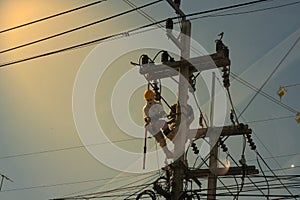 Technician work on high voltage electicity pole with copy space and reflect light