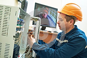 Technician worker adjusting video surveillance system