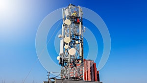 Technician worker climbing on a telephone radio network mast installing new antenna