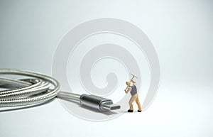 Technician worker figure standing in front of usb USB type C cable. IT support concept